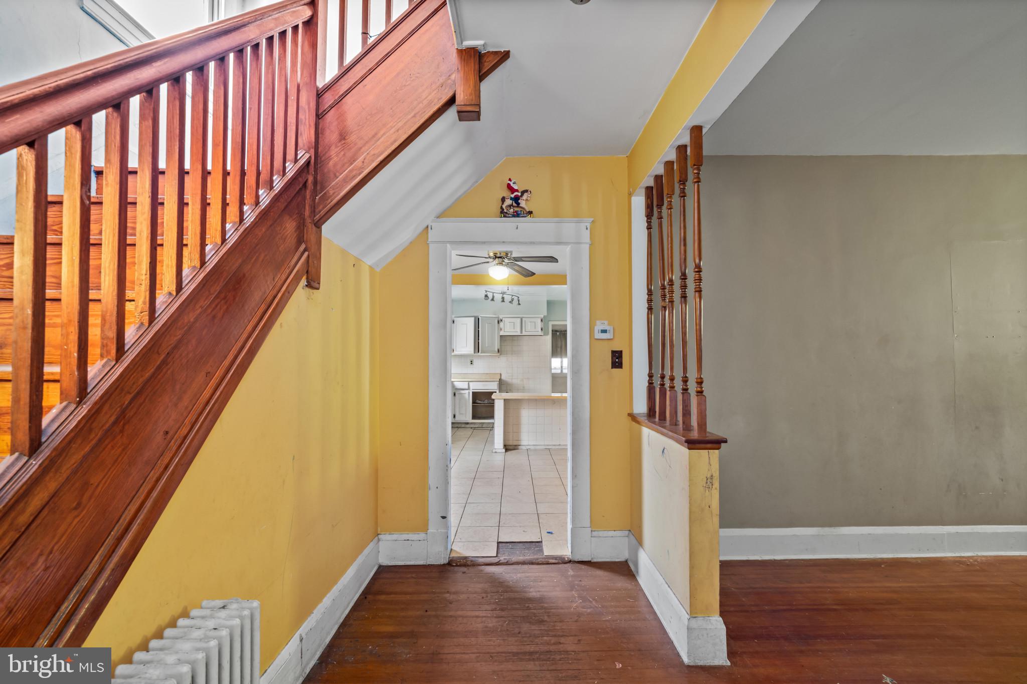 2908 Ailsa Avenue Baltimore, MD 21214 - Photo 4 of 29 a view of hallway with stairs and wooden floor