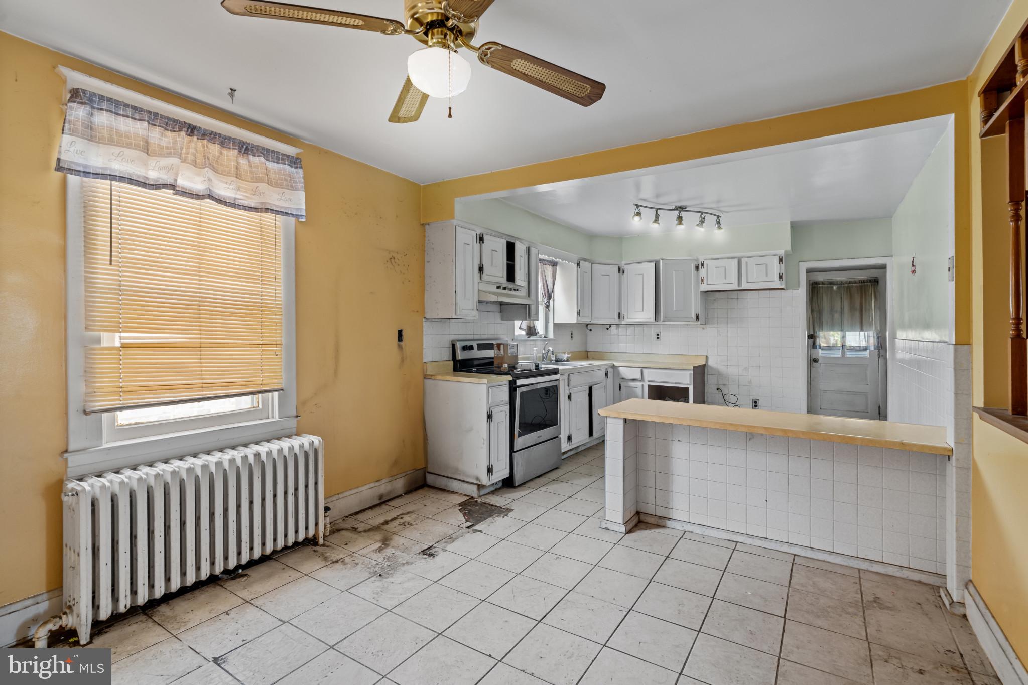 2908 Ailsa Avenue Baltimore, MD 21214 - Photo 10 of 29 a kitchen with white cabinets and appliances