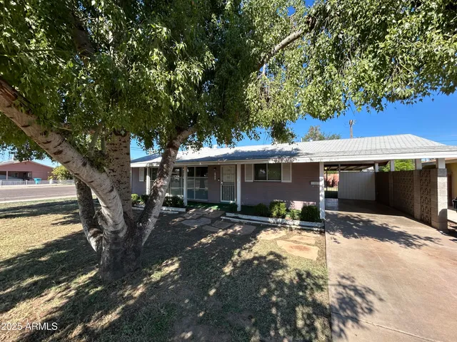 a view of a house with a tree in a yard