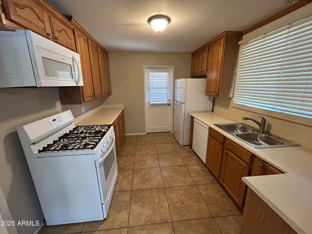 a kitchen with a stove sink and cabinets