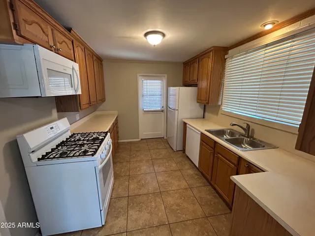 a kitchen with a stove a sink and a refrigerator