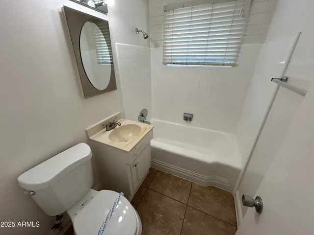 a white toilet sitting next to a bathroom sink