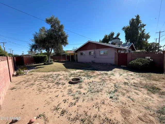 a view of a house with a yard covered in snow
