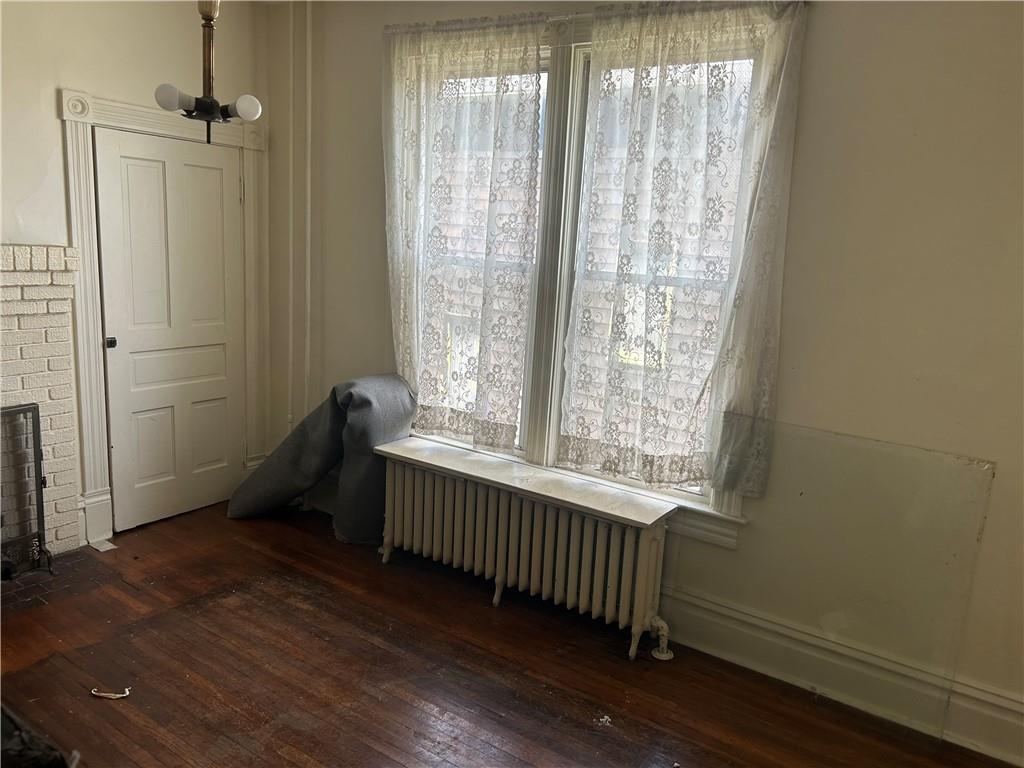306 4th Street Monessen, PA 15062 - Photo 11 of 18 a view of an empty room with wooden floor and a window