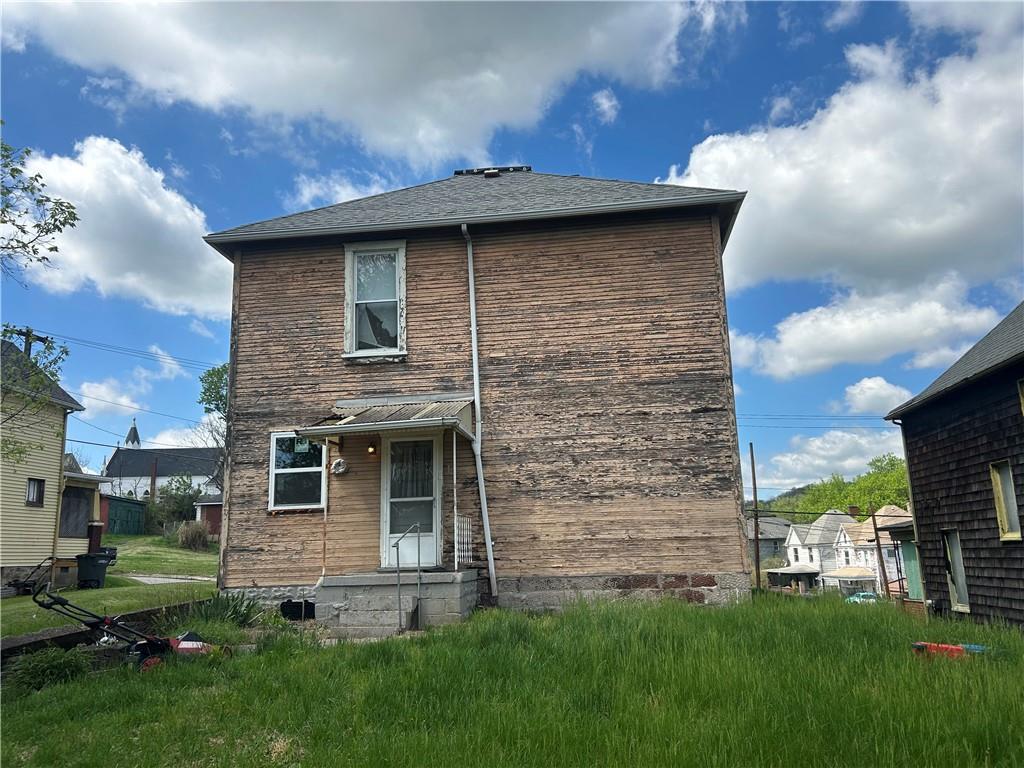 306 4th Street Monessen, PA 15062 - Photo 4 of 18 a brick house with a garden