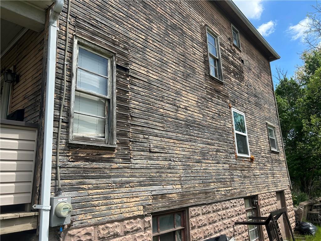 306 4th Street Monessen, PA 15062 - Photo 7 of 18 a view of a house with a door and wooden walls