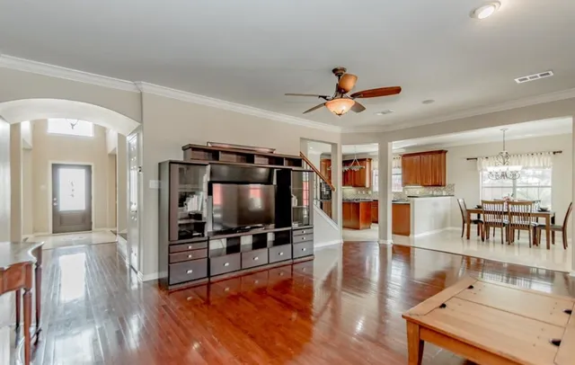 a living room with dining room and wooden floor
