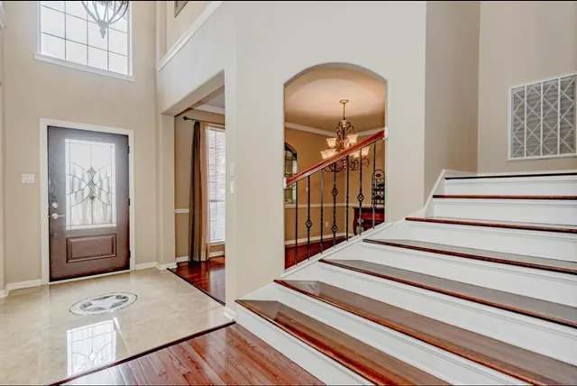 a view of entryway and hall with wooden floor