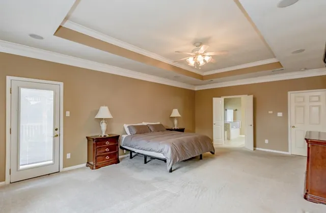 a bedroom with bed and a chandelier