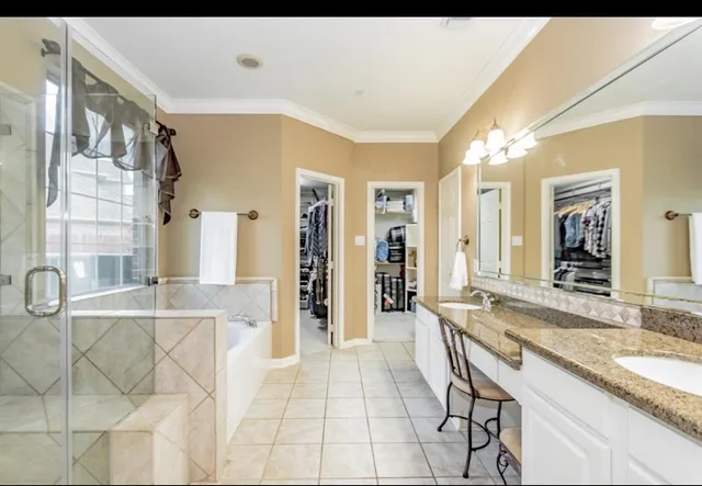 a spacious bathroom with a granite countertop sink a mirror and a shower