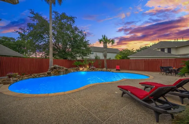 a view of a pool with sitting area