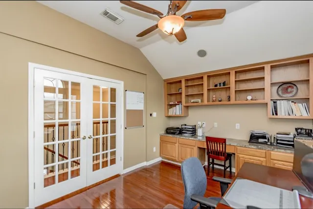 a view of a workspace with furniture and a kitchen