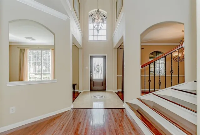 a view of a livingroom with wooden floor and a ceiling fan