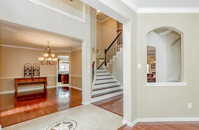 a view of a hallway with wooden floor fireplace and dining room