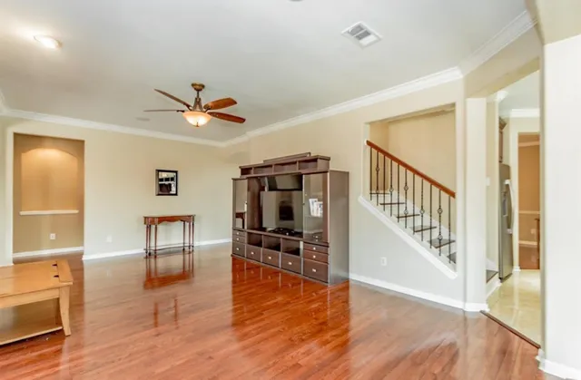 a view of a livingroom with furniture wooden floor and windows