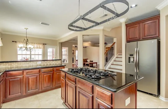 a kitchen with stainless steel appliances a stove a sink and a refrigerator