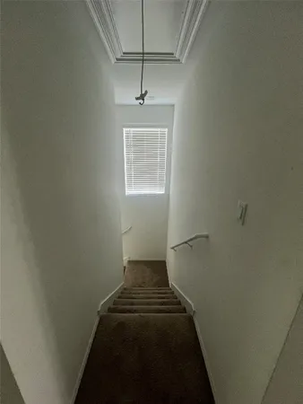 a view of a hallway with a window