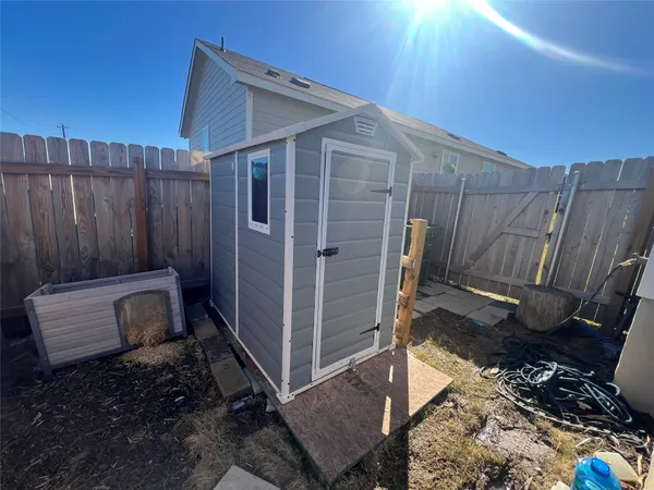 a view of a backyard with wooden fence