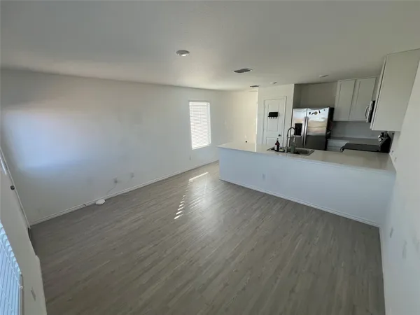 a view of a furniture and wooden floor in a room