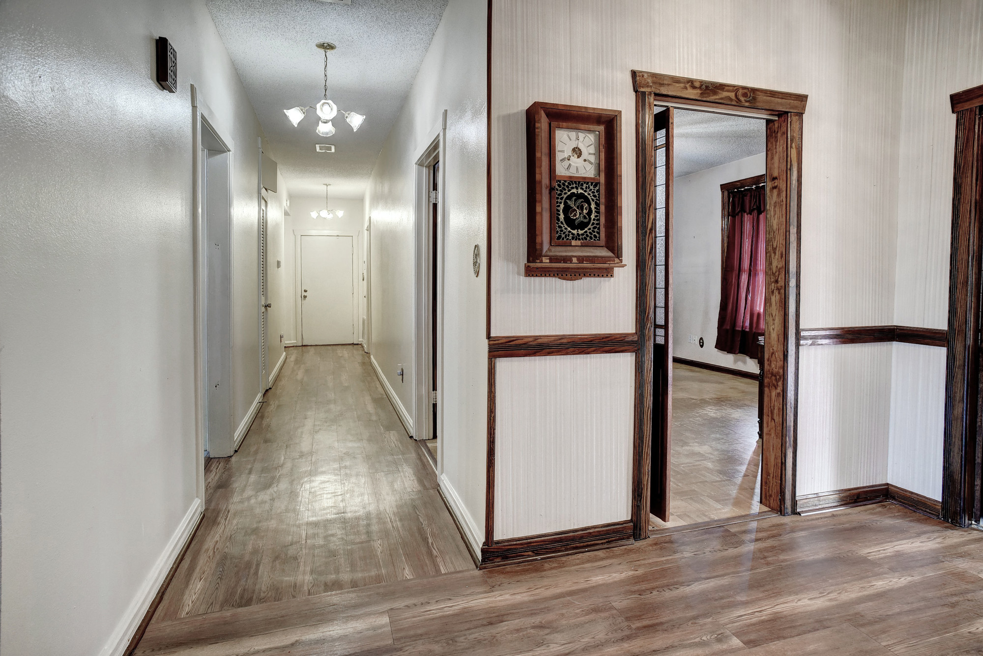 113 My Road Bastrop, TX 78602 - Photo 11 of 35 Hall featuring a textured ceiling, a chandelier, and light wood finished floors