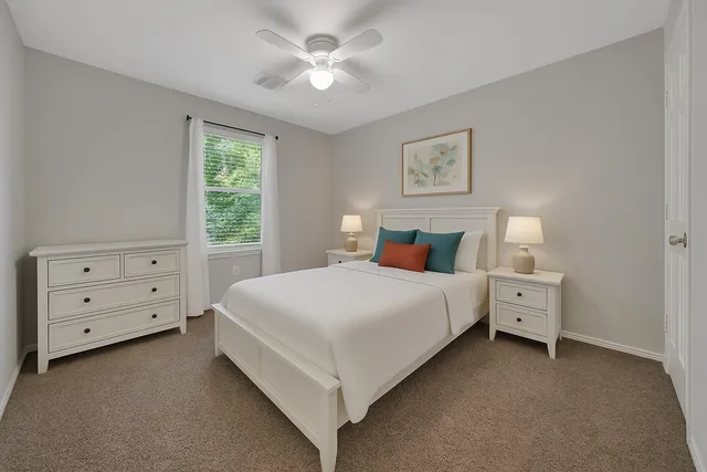 a bed room with a bed and a window