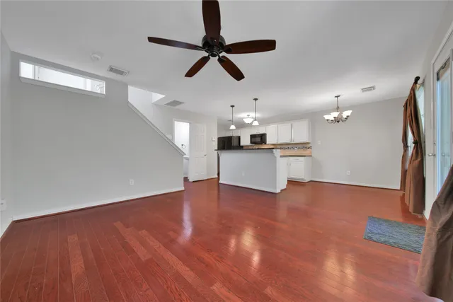 a view of a kitchen with a sink cabinets and wooden floor