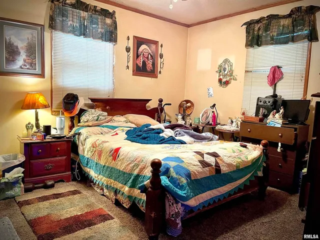 a bed room with a bed and paintings on the wall