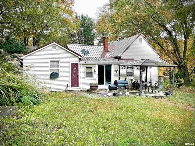 a front view of house with yard and seating area