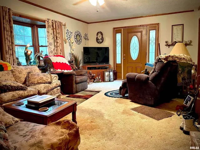 a living room with furniture a window and a flat screen tv