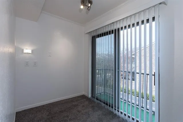 a view of an empty room and a ceiling fan