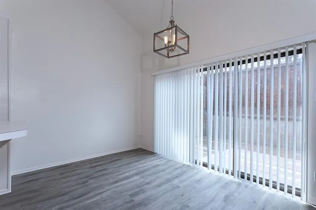 a view of a room with wooden floor and window