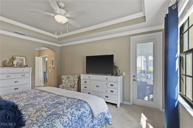 a bedroom with a bed and a flat tv screen on dresser