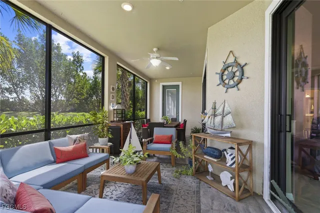a living room with furniture and a floor to ceiling window