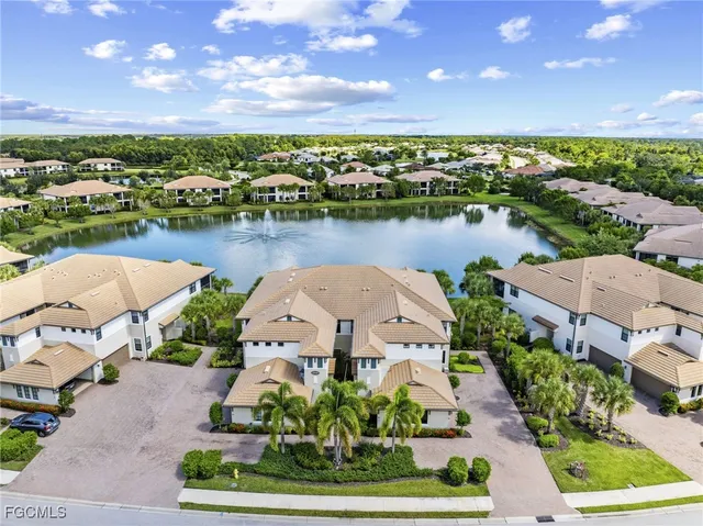 an aerial view of a house with outdoor space and lake view