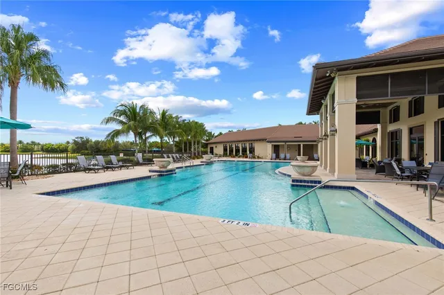 a view of a house with swimming pool and sitting area