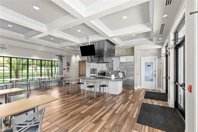 a view of a living room and kitchen floor to ceiling window or kitchen