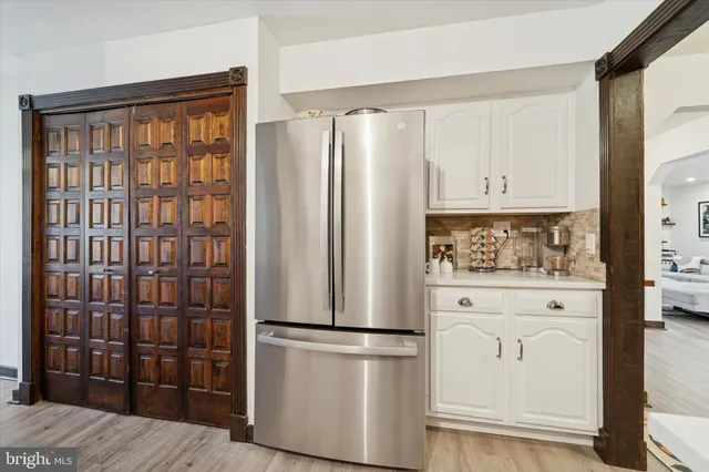 a kitchen with stainless steel appliances a refrigerator and cabinets