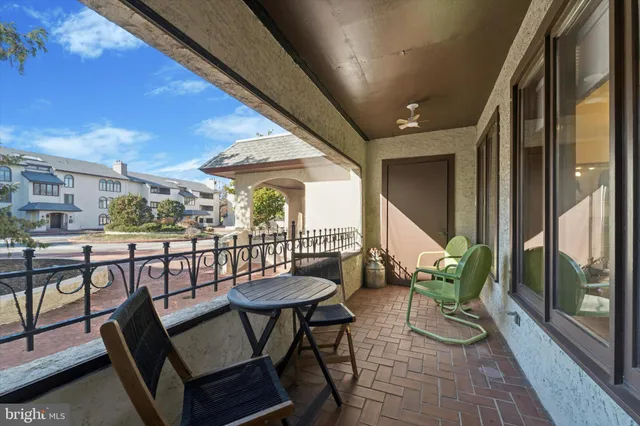 a view of a chairs and table in the balcony