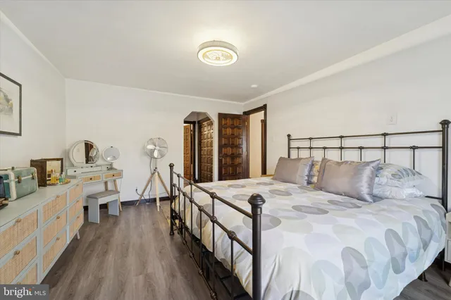 a bedroom with a bed and a large window