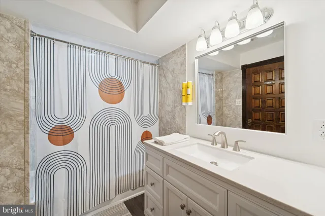 a bathroom with a sink a mirror and a bathtub