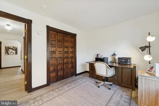 a view of a workspace with furniture and a window