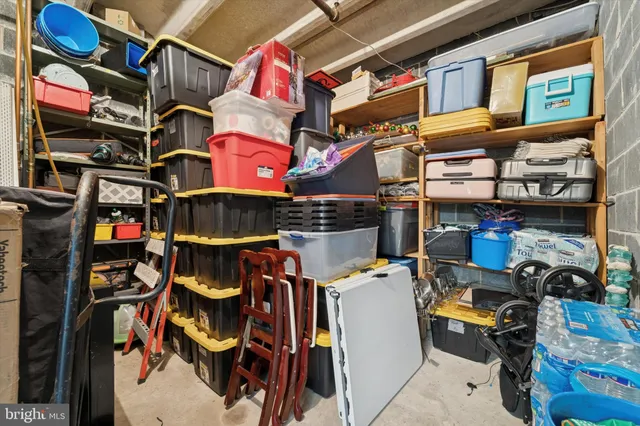 a view of swimming pool with seating area and trees in the background