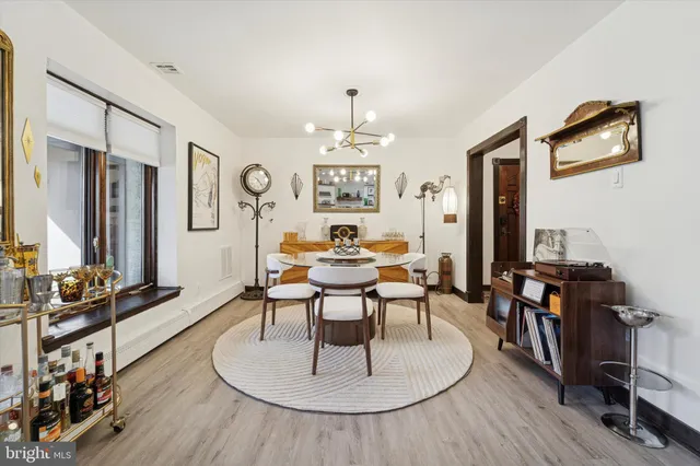 a view of a a dining room with furniture window and wooden floor