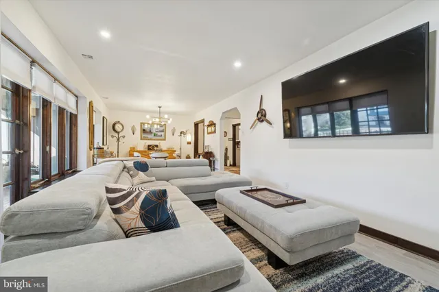 a living room with furniture and a ceiling fan