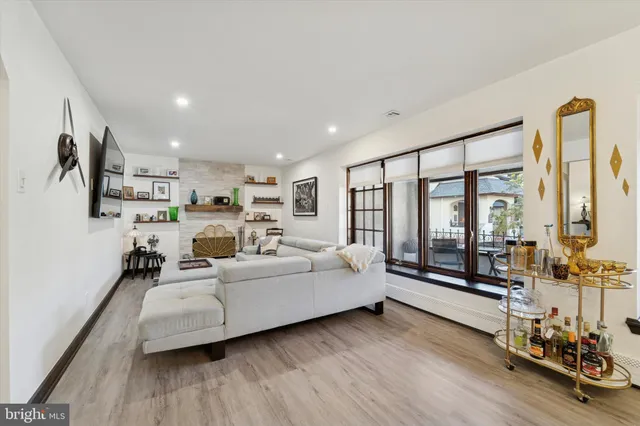 a living room with furniture window and wooden floor