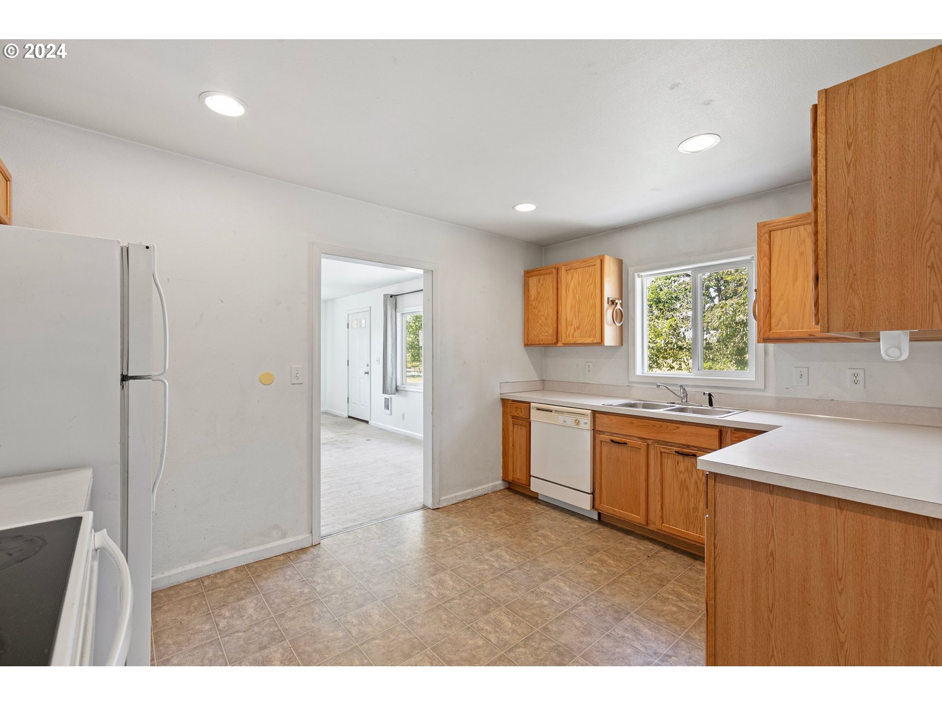 179 35th Street Springfield, OR 97478 - Photo 11 of 46 a kitchen with granite countertop a sink stainless steel appliances and cabinets