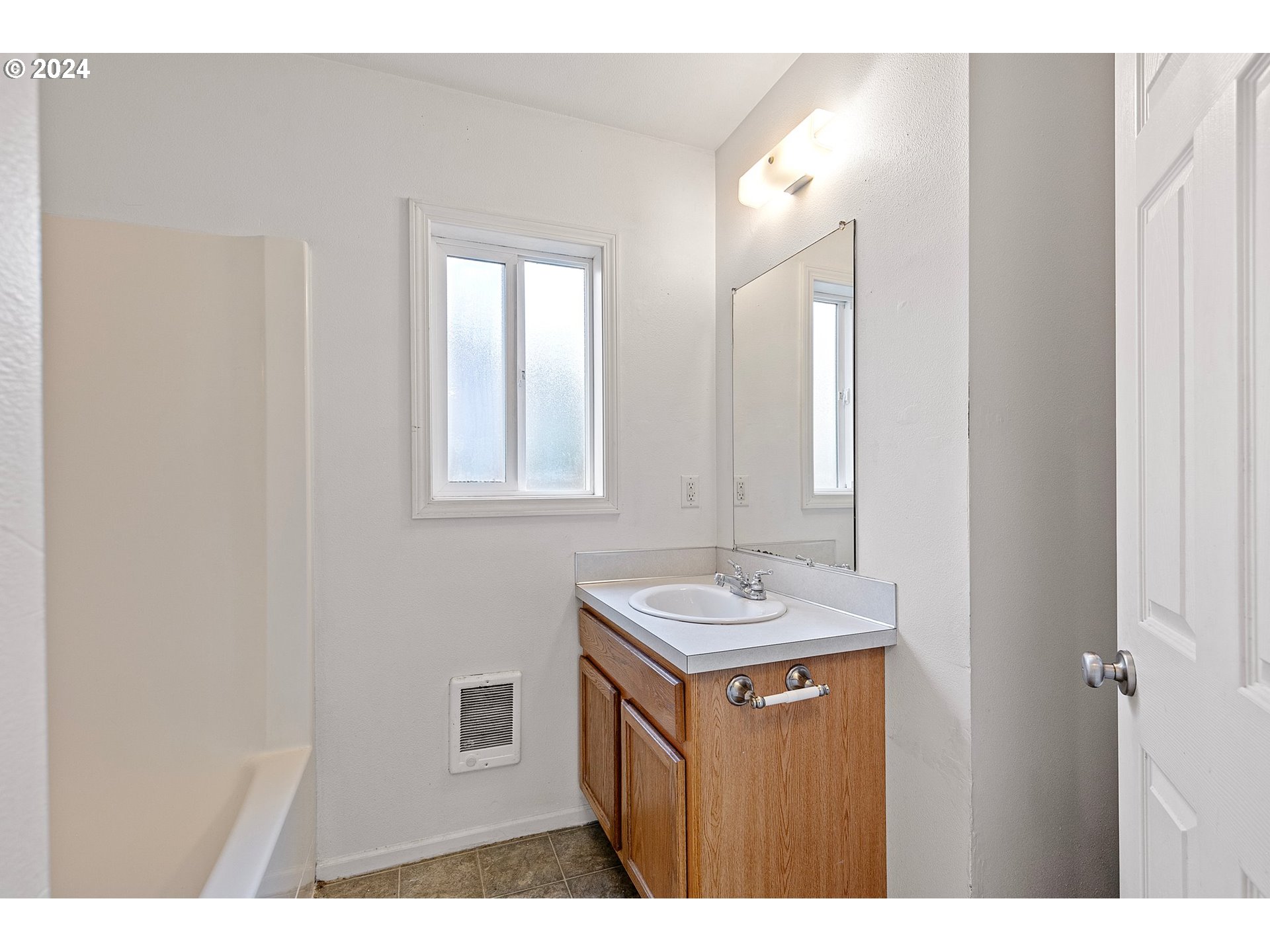 179 35th Street Springfield, OR 97478 - Photo 14 of 46 a bathroom with a sink a mirror and a vanity