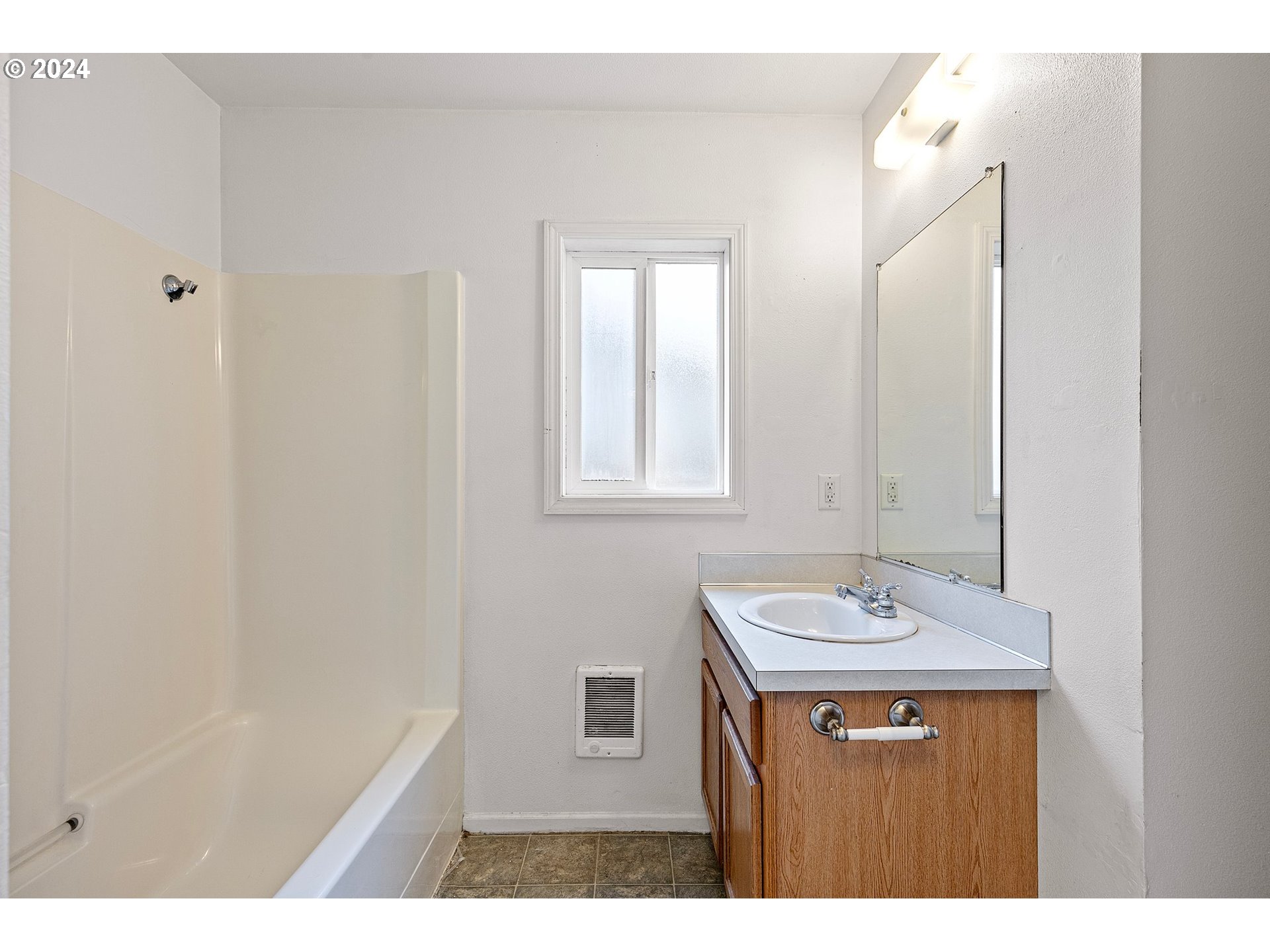 179 35th Street Springfield, OR 97478 - Photo 15 of 46 a bathroom with a sink a mirror and a shower