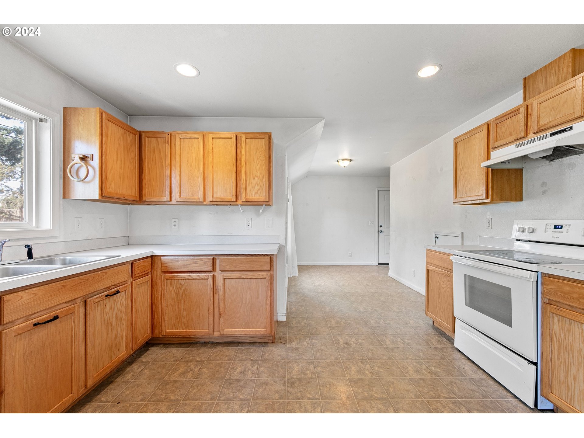 179 35th Street Springfield, OR 97478 - Photo 6 of 46 a kitchen with stainless steel appliances granite countertop a sink and cabinets with wooden floor