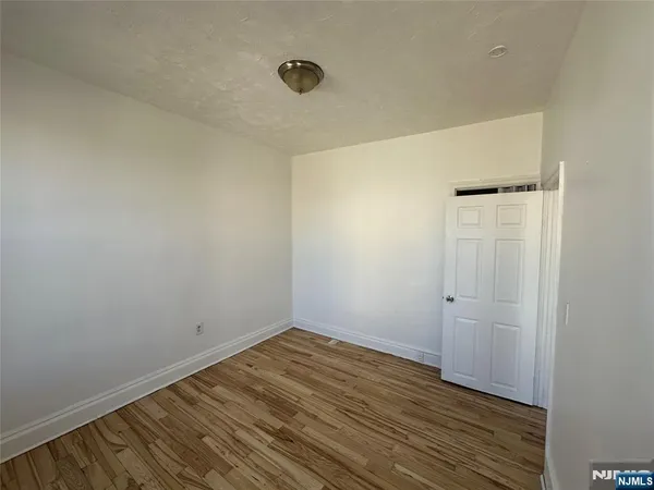 a view of room with wooden floor